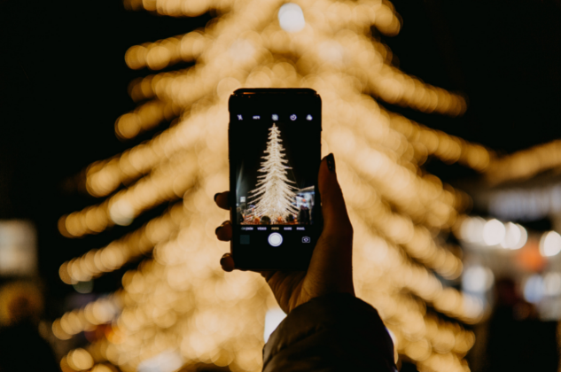 Mobile phone taking picture of Christmas tree